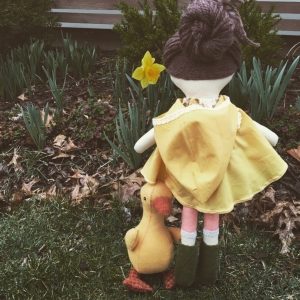 Make-Along doll playing in the rain with her pet duck